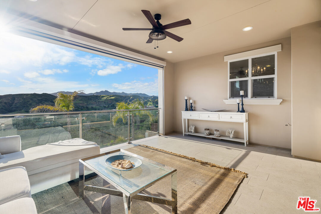 12015 North Ricasoli Way Porter Ranch, CA 91326 - Photo 38 of 68 a living room with furniture and a floor to ceiling window