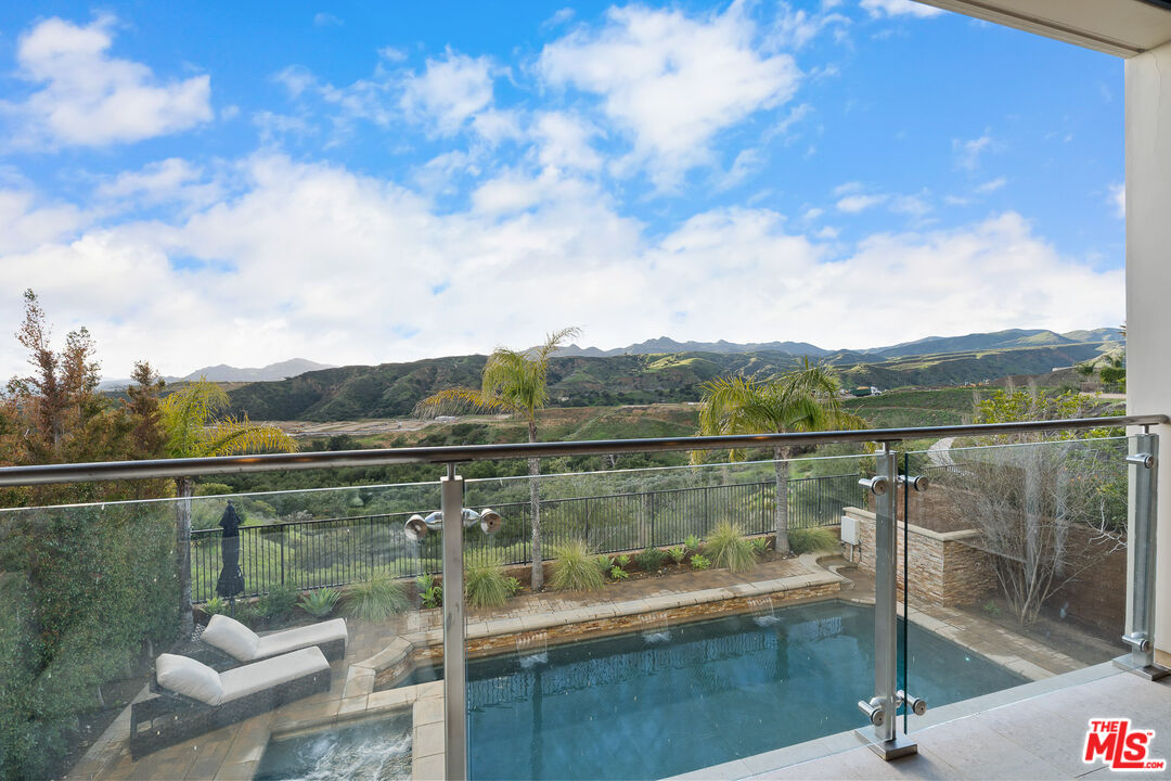 12015 North Ricasoli Way Porter Ranch, CA 91326 - Photo 42 of 68 a view of a lake from a balcony with outdoor seating