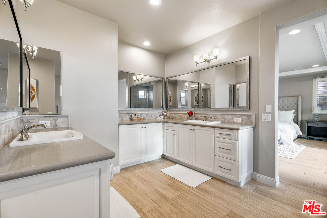 12015 North Ricasoli Way Porter Ranch, CA 91326 - Photo 49 of 68 a large white bathroom with a sink and mirror