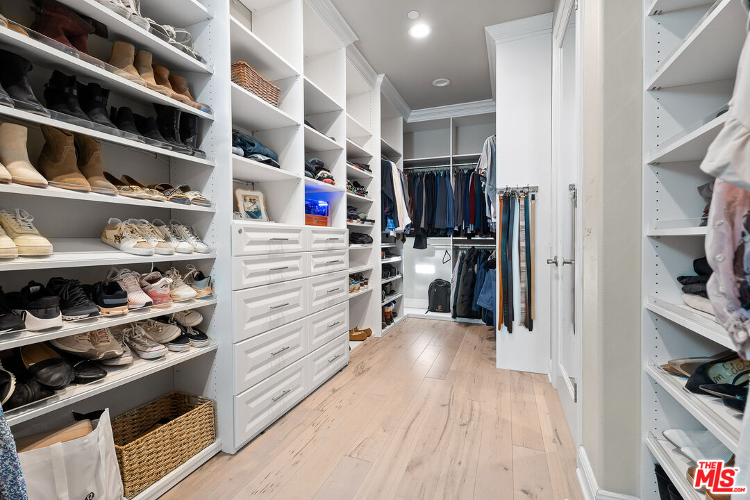 12015 North Ricasoli Way Porter Ranch, CA 91326 - Photo 50 of 68 a view of walk in closet with clothes and shoes