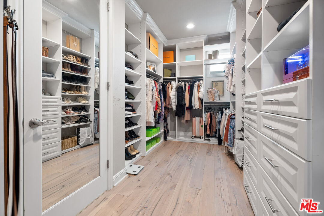 12015 North Ricasoli Way Porter Ranch, CA 91326 - Photo 51 of 68 a view of walk in closet with clothes and shoes