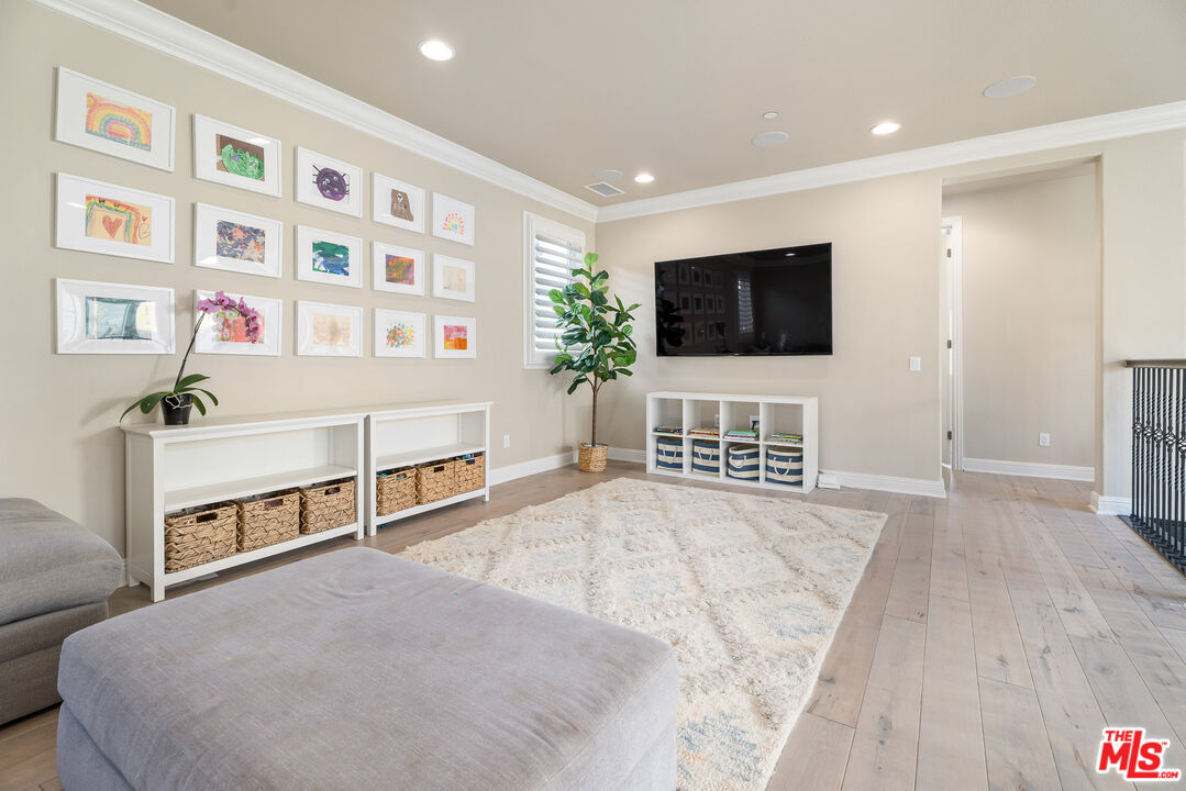 12015 North Ricasoli Way Porter Ranch, CA 91326 - Photo 55 of 68 a spacious bedroom with a bed and a flat screen tv