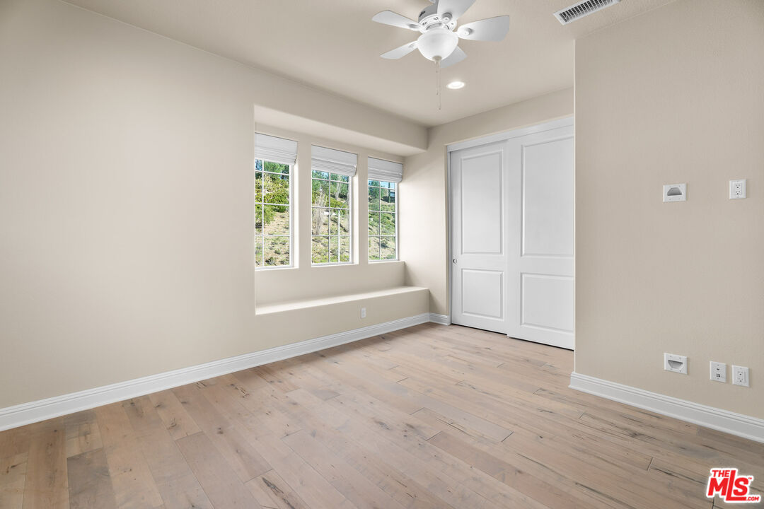 12015 North Ricasoli Way Porter Ranch, CA 91326 - Photo 57 of 68 wooden floor in an empty room with a window