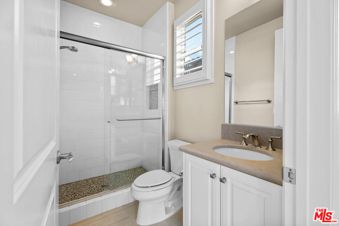 12015 North Ricasoli Way Porter Ranch, CA 91326 - Photo 58 of 68 a bathroom with a granite countertop sink toilet and shower
