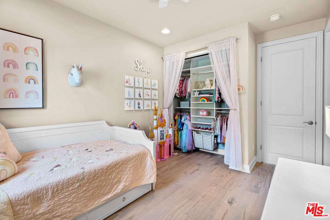 12015 North Ricasoli Way Porter Ranch, CA 91326 - Photo 61 of 68 a bedroom with a bed and a wooden floor