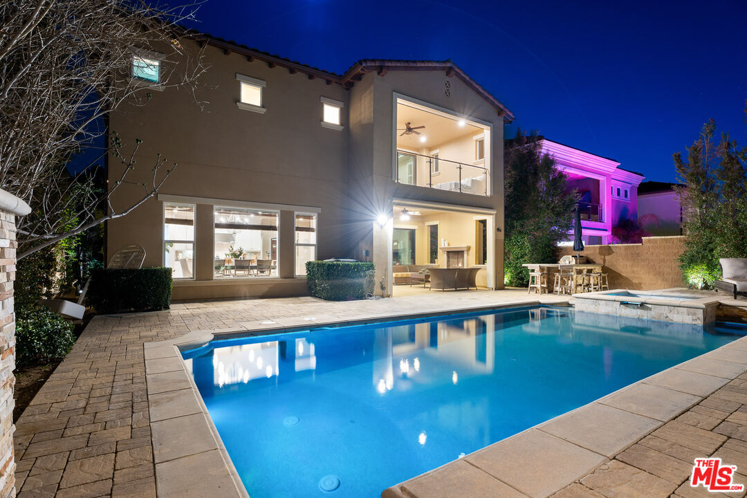 12015 North Ricasoli Way Porter Ranch, CA 91326 - Photo 7 of 68 a large swimming pool with outdoor seating