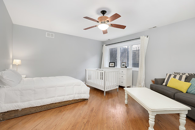 1731 South Ruble Street, Unit 1 Chicago, IL 60616 - Photo 15 of 25 a bedroom with a bed and a chandelier