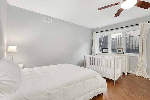 1731 South Ruble Street, Unit 1 Chicago, IL 60616 - Photo 17 of 25 a bedroom with a bed and a large window