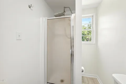 a bathroom with a glass shower door