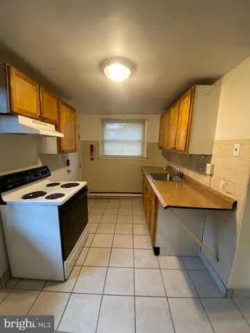 a kitchen with a sink counter top space and a window