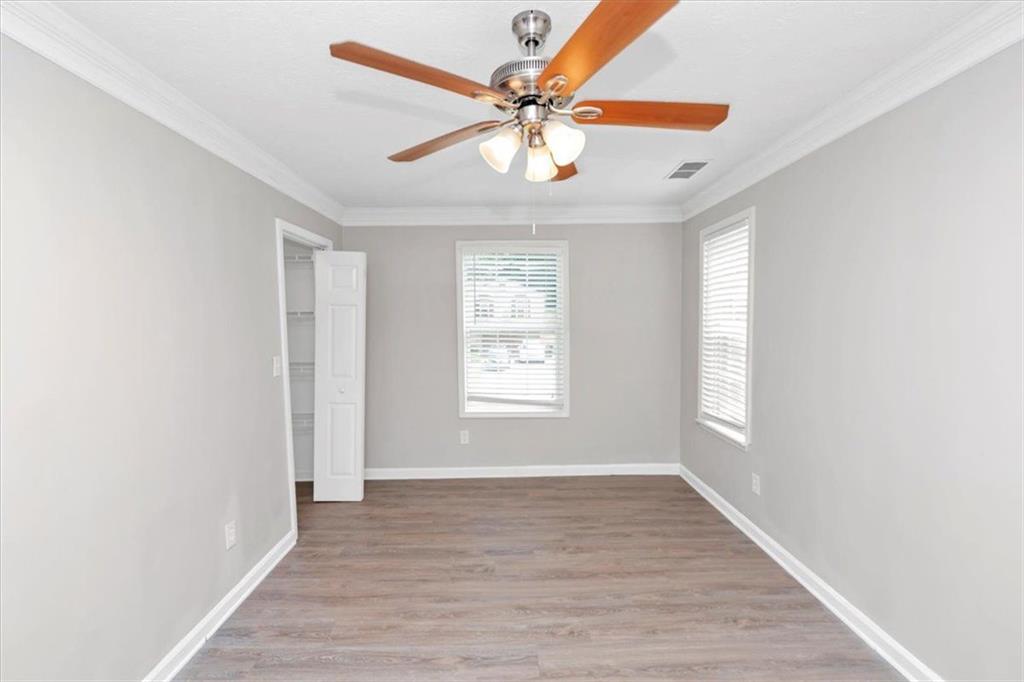 710 Country Manor Way Alpharetta, GA 30022 - Photo 12 of 33 a view of an empty room with wooden floor and a window