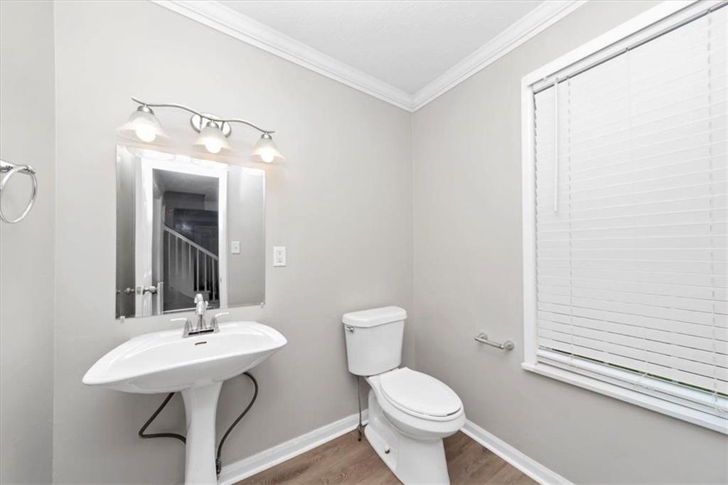 710 Country Manor Way Alpharetta, GA 30022 - Photo 13 of 33 a bathroom with a toilet a sink and mirror