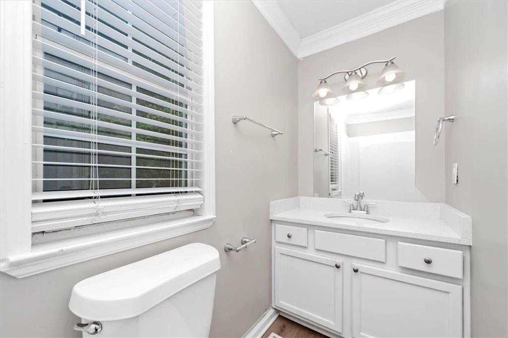 710 Country Manor Way Alpharetta, GA 30022 - Photo 20 of 33 a bathroom with a toilet a sink and a window