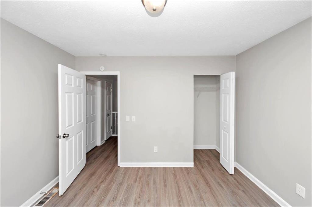 710 Country Manor Way Alpharetta, GA 30022 - Photo 21 of 33 a view of a room with wooden floor and white doors
