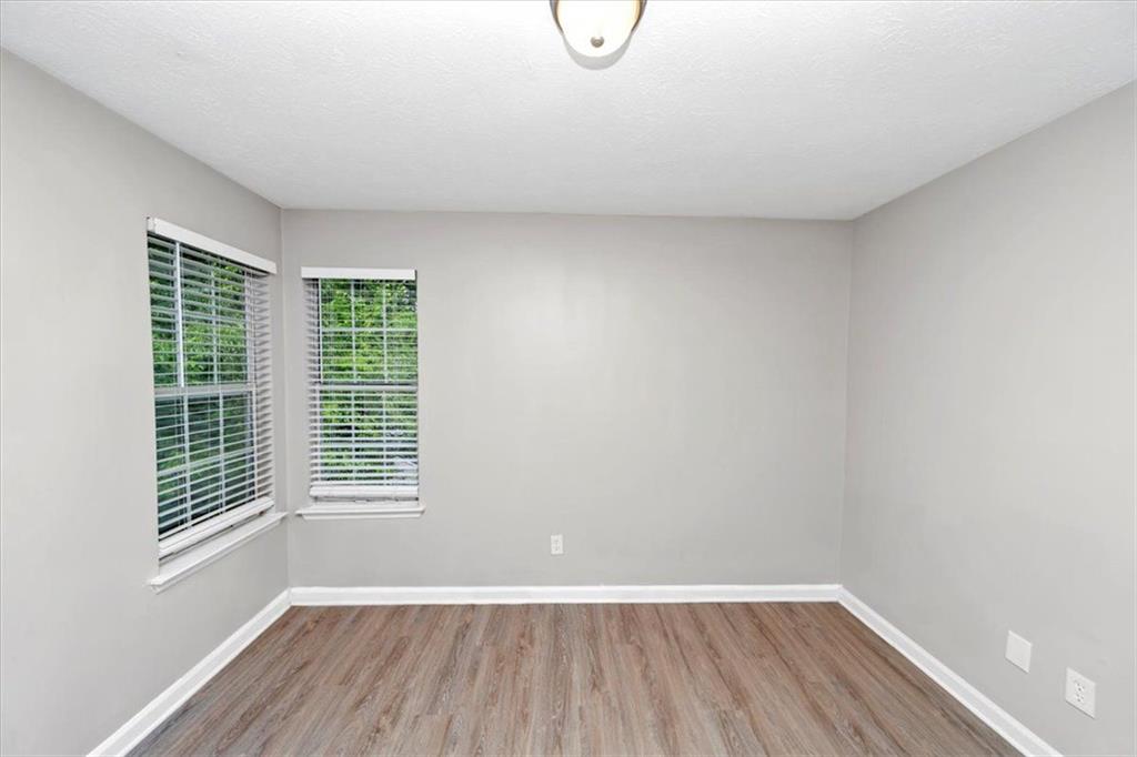 710 Country Manor Way Alpharetta, GA 30022 - Photo 22 of 33 a view of a room with wooden floor and windows
