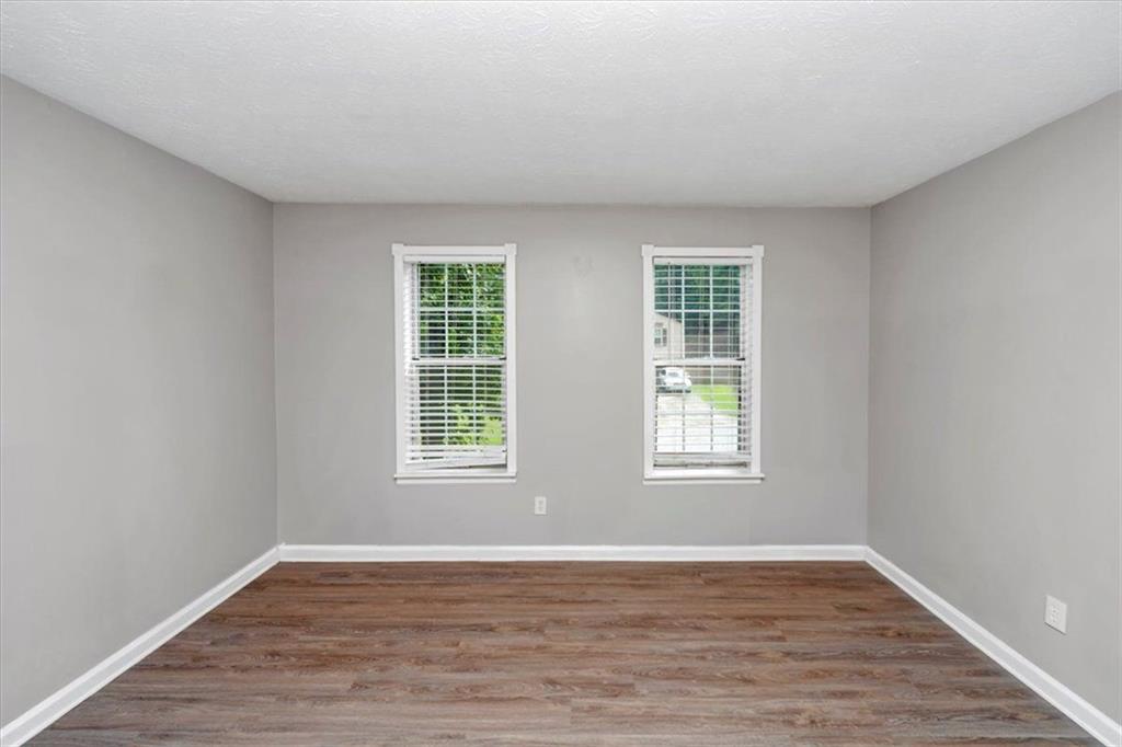 710 Country Manor Way Alpharetta, GA 30022 - Photo 23 of 33 a view of an empty room with wooden floor and window
