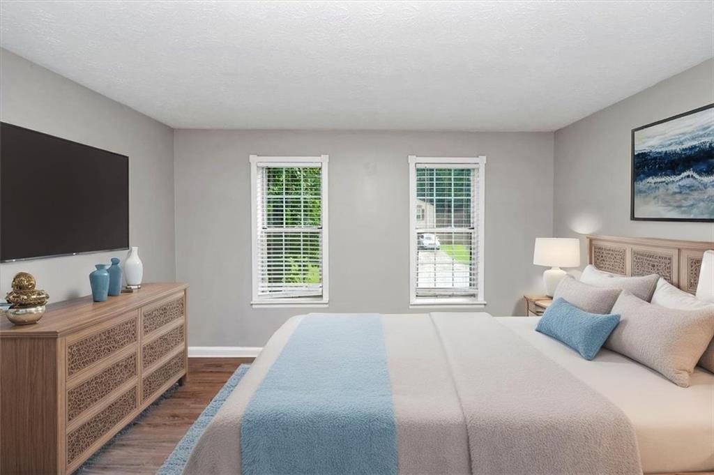 710 Country Manor Way Alpharetta, GA 30022 - Photo 24 of 33 a bedroom with a bed and a flat screen tv