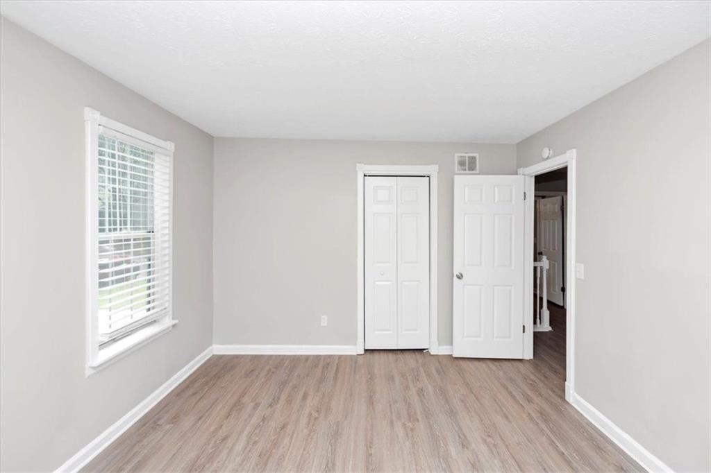 710 Country Manor Way Alpharetta, GA 30022 - Photo 26 of 33 an empty room with wooden floor and windows