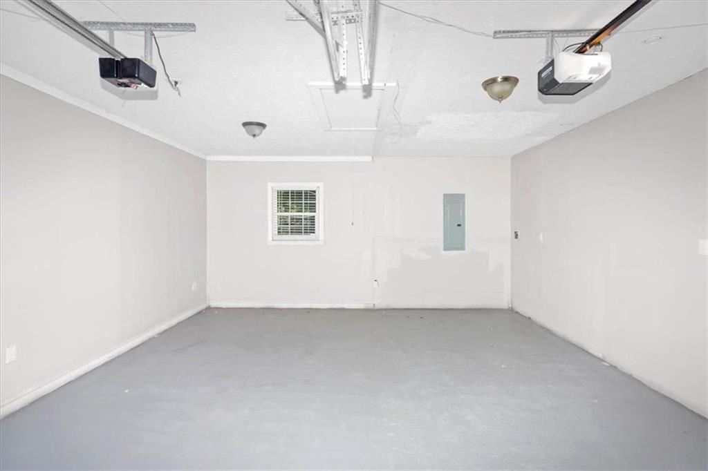 710 Country Manor Way Alpharetta, GA 30022 - Photo 28 of 33 an empty room with a ceiling fan and windows
