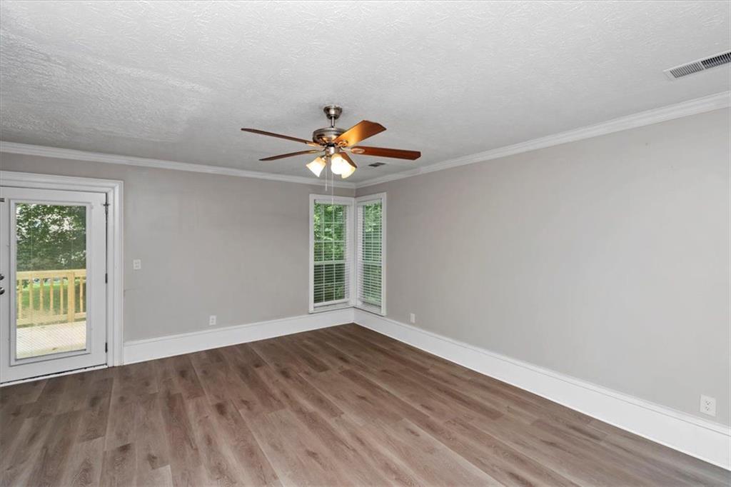 710 Country Manor Way Alpharetta, GA 30022 - Photo 3 of 33 wooden floor in an empty room with a window