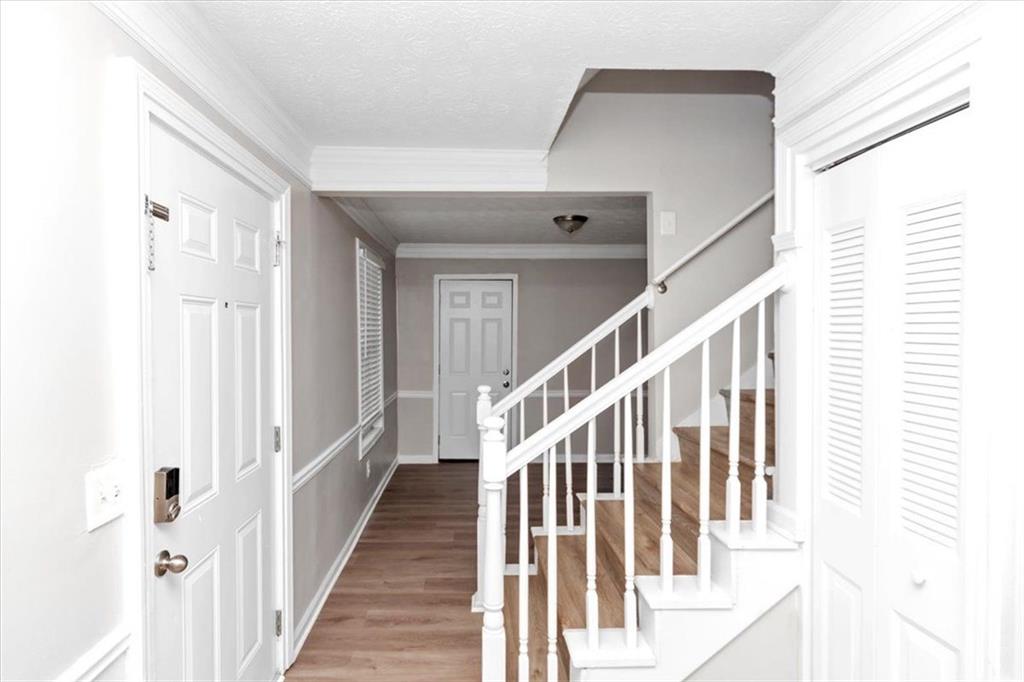 710 Country Manor Way Alpharetta, GA 30022 - Photo 4 of 33 a view of a hallway with wooden floor and entryway