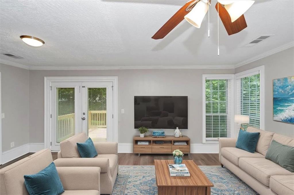 710 Country Manor Way Alpharetta, GA 30022 - Photo 5 of 33 a living room with furniture and a flat screen tv