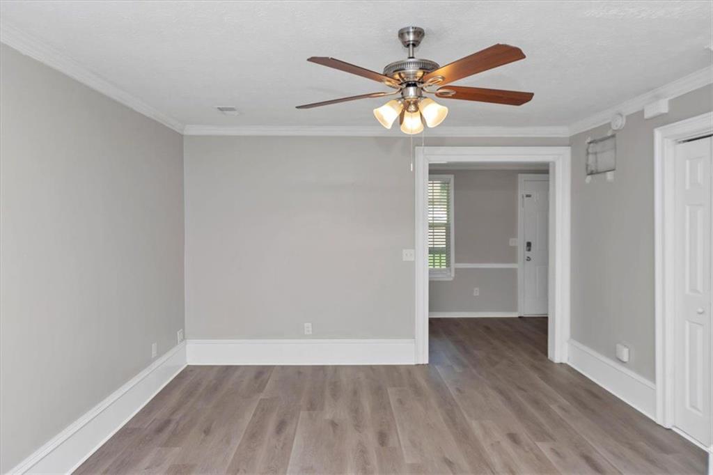 710 Country Manor Way Alpharetta, GA 30022 - Photo 6 of 33 a view of an empty room with wooden floor and a ceiling fan