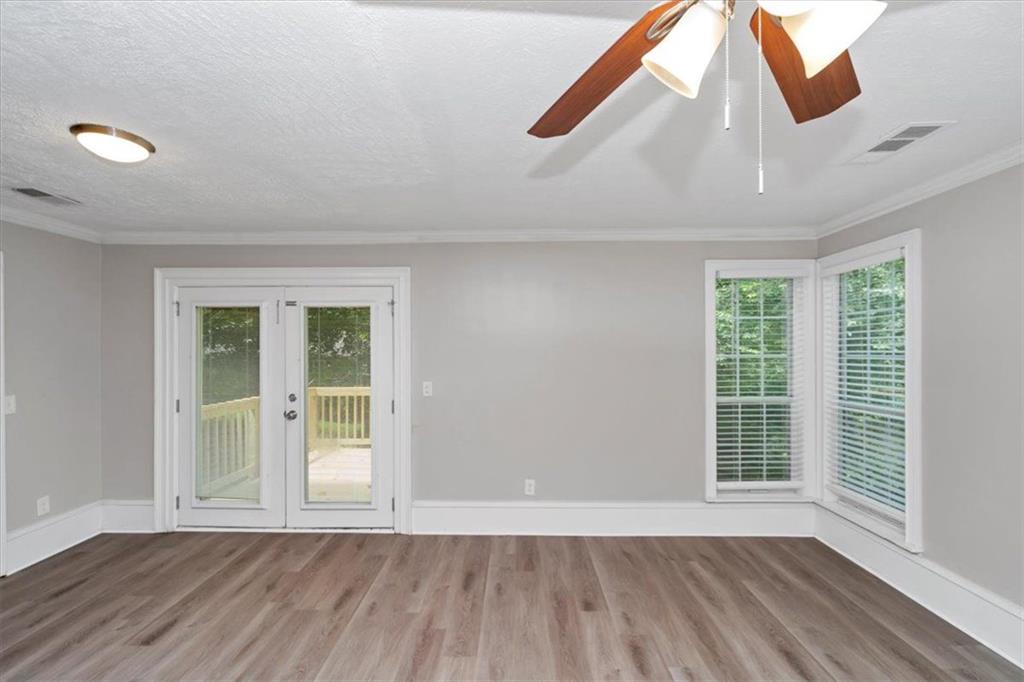 710 Country Manor Way Alpharetta, GA 30022 - Photo 7 of 33 a view of an empty room with wooden floor and a window