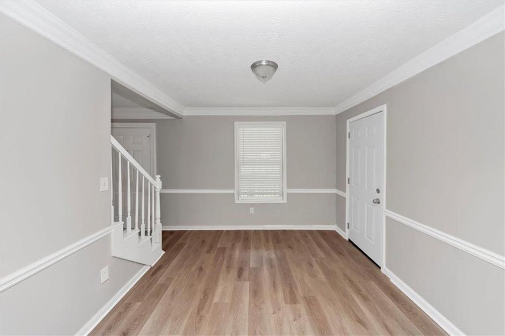 710 Country Manor Way Alpharetta, GA 30022 - Photo 9 of 33 a view of a room with wooden floors and white walls