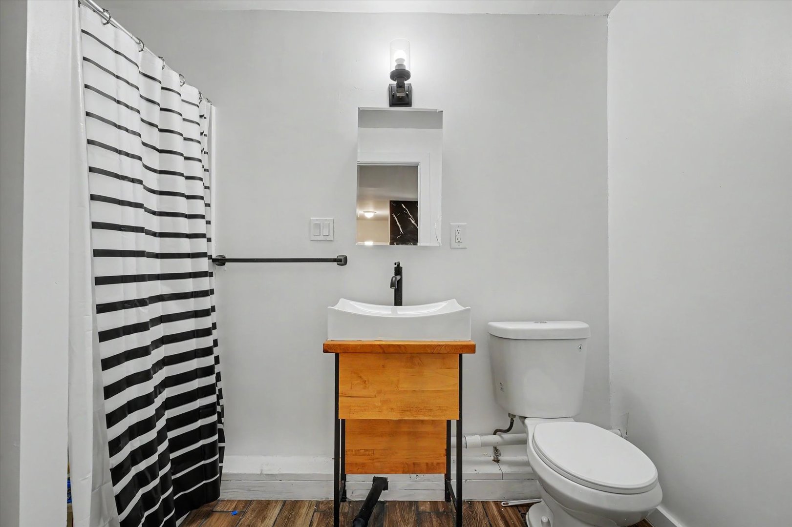 2431 North 1450 East Road Mansfield, IL 61854 - Photo 55 of 78 a bathroom with a toilet a sink and mirror