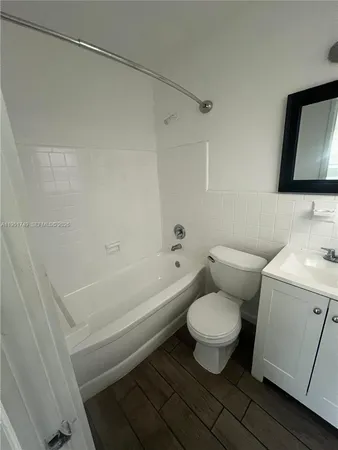 a bathroom with a toilet and a bathtub