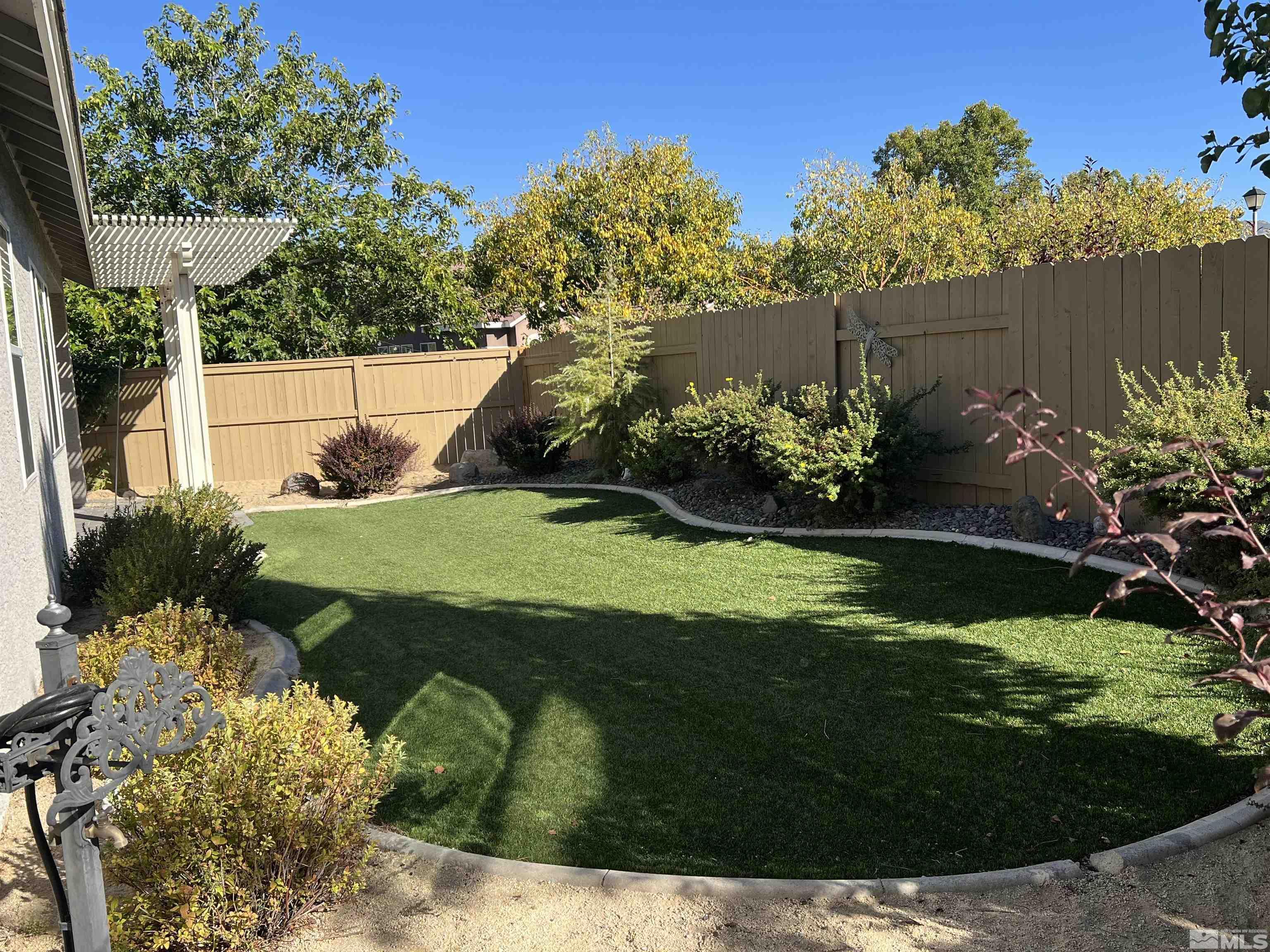 10600 Silver Cliff Way Reno, NV 89521 - Photo 21 of 24 a view of a garden with a fountain