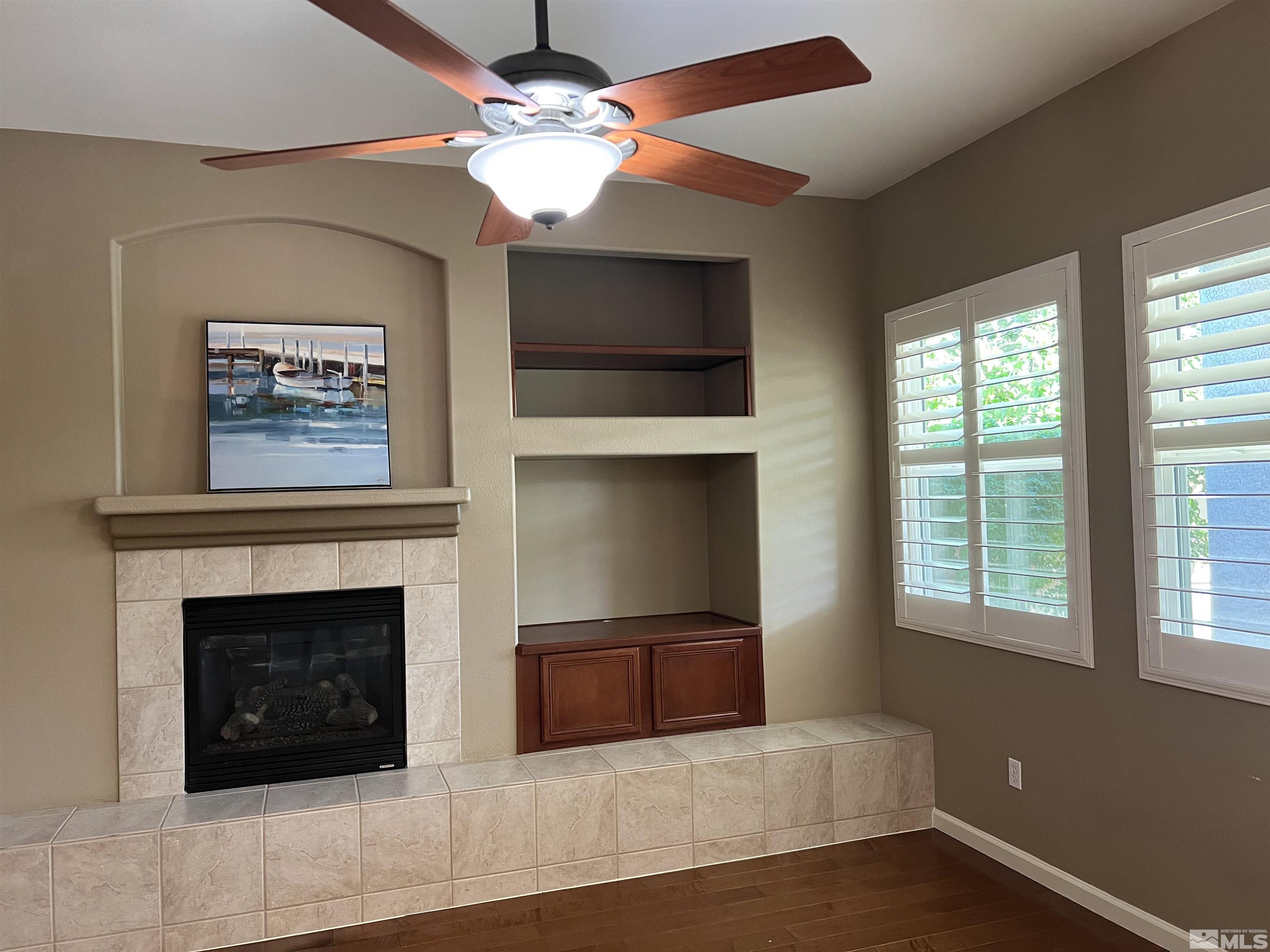 10600 Silver Cliff Way Reno, NV 89521 - Photo 8 of 24 a living room with a fireplace and a flat screen tv