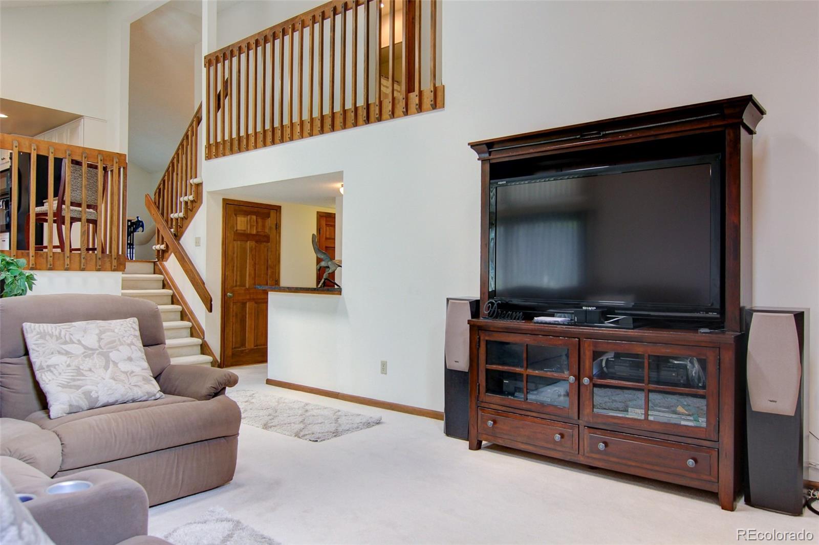 8096 Sweet Water Road Lone Tree, CO 80124 - Photo 11 of 25 a living room with furniture and a flat screen tv