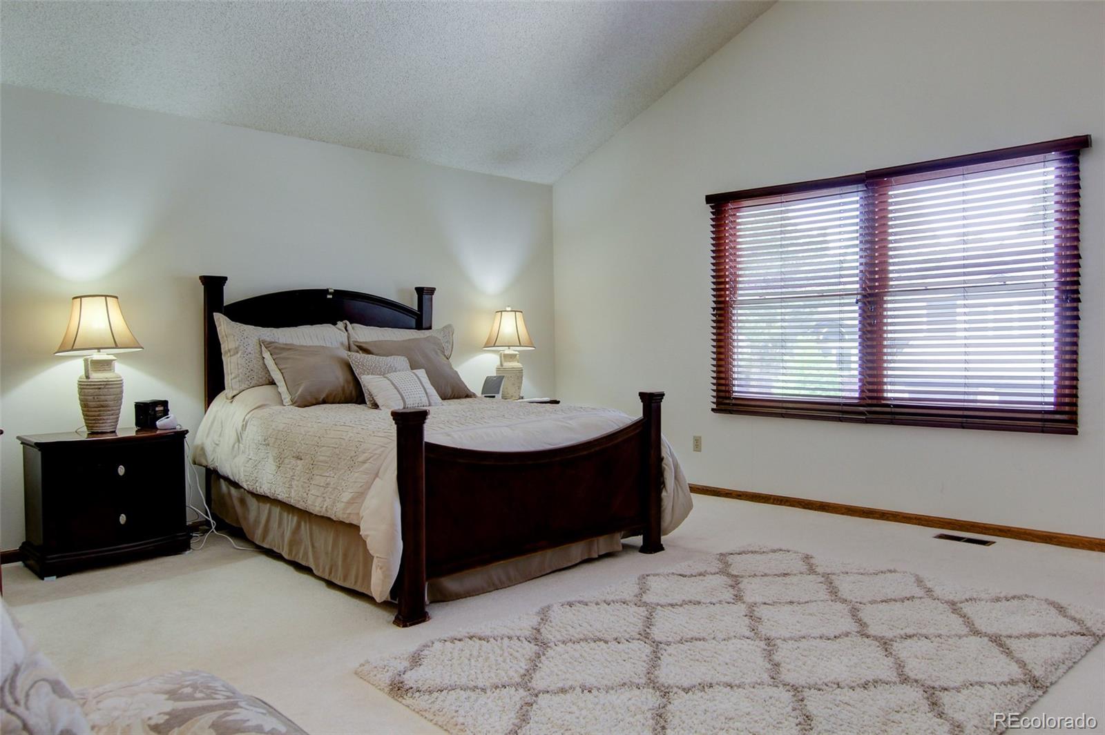 8096 Sweet Water Road Lone Tree, CO 80124 - Photo 12 of 25 a bedroom with a bed and window