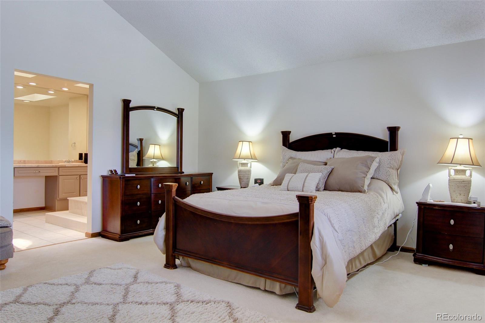 8096 Sweet Water Road Lone Tree, CO 80124 - Photo 13 of 25 a bedroom with a bed and a dresser
