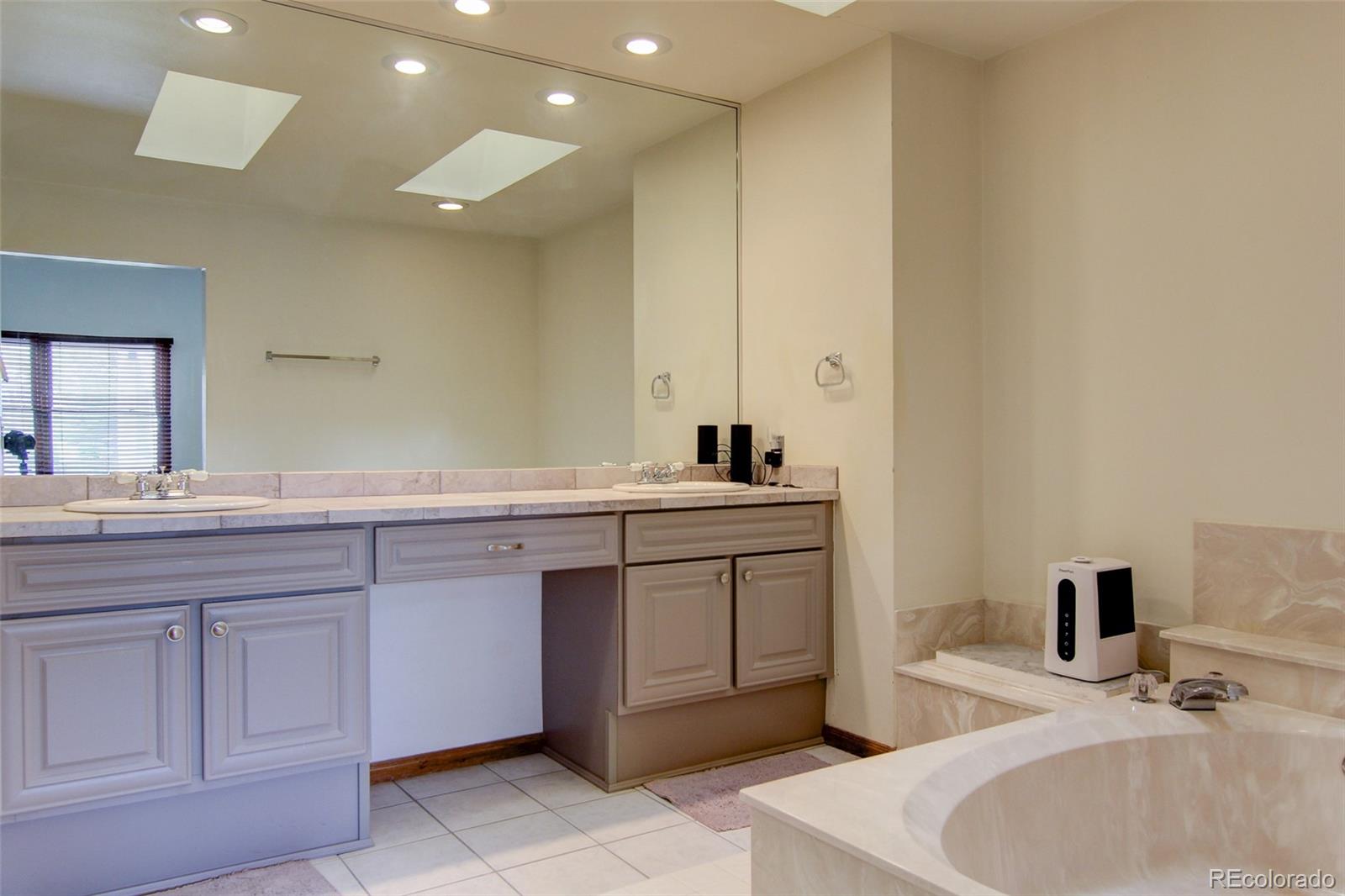 8096 Sweet Water Road Lone Tree, CO 80124 - Photo 14 of 25 a bathroom with a sink and a toilet