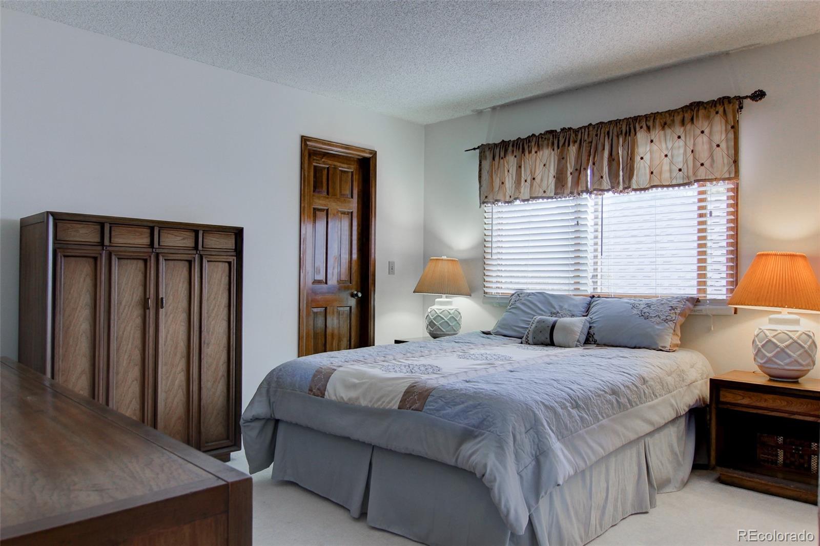 8096 Sweet Water Road Lone Tree, CO 80124 - Photo 17 of 25 a bedroom with double bed and a window