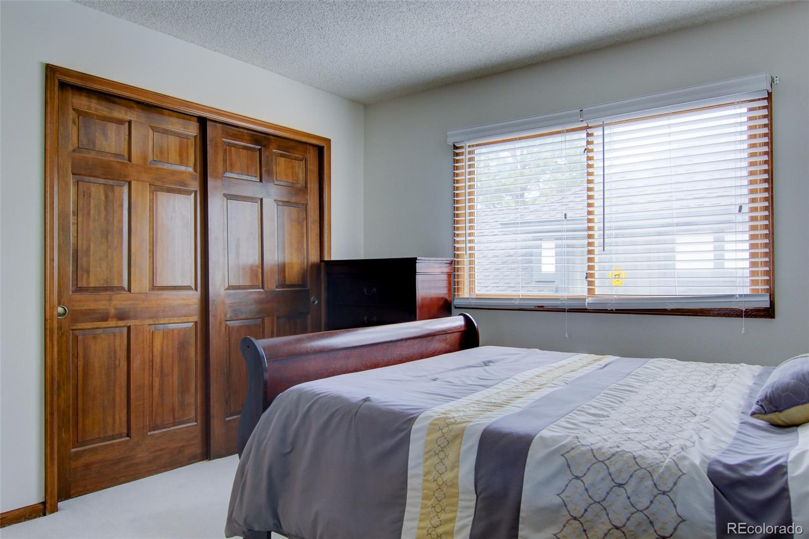 8096 Sweet Water Road Lone Tree, CO 80124 - Photo 19 of 25 a bedroom with a bed and a window