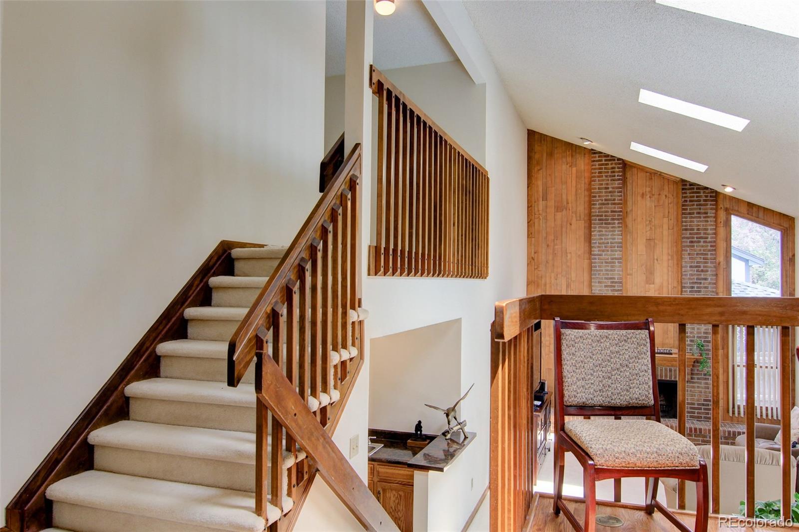 8096 Sweet Water Road Lone Tree, CO 80124 - Photo 7 of 25 a view of entryway with wooden floor and stairs