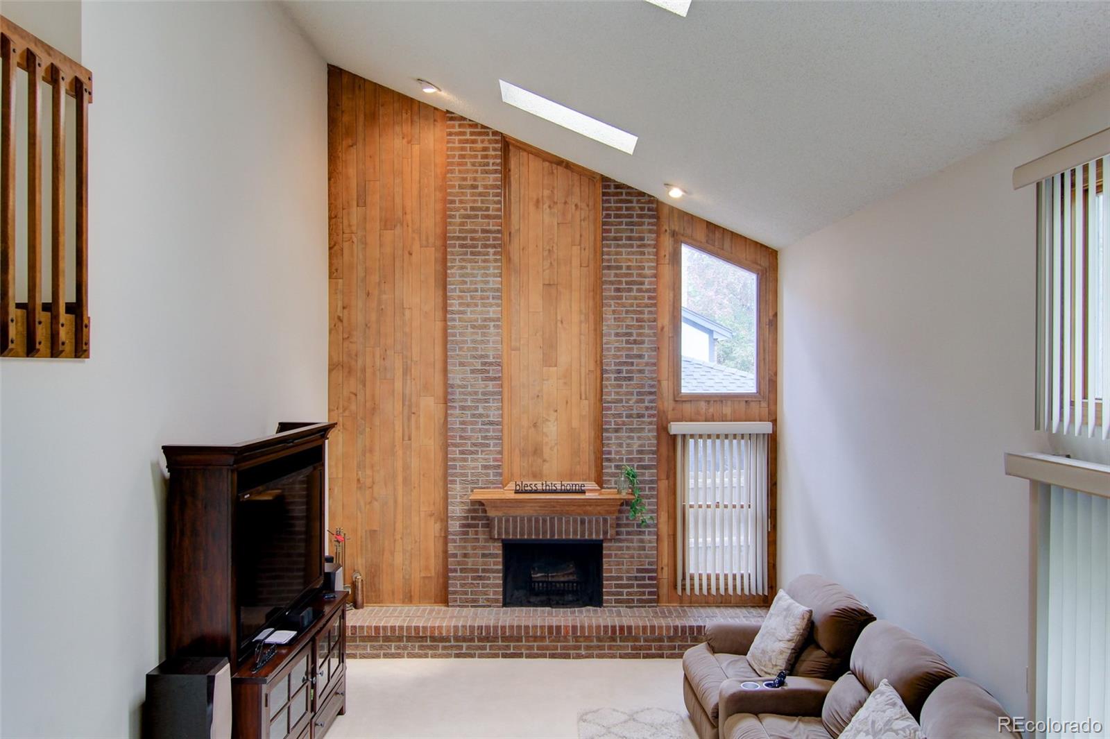 8096 Sweet Water Road Lone Tree, CO 80124 - Photo 8 of 25 a living room with furniture and a fireplace