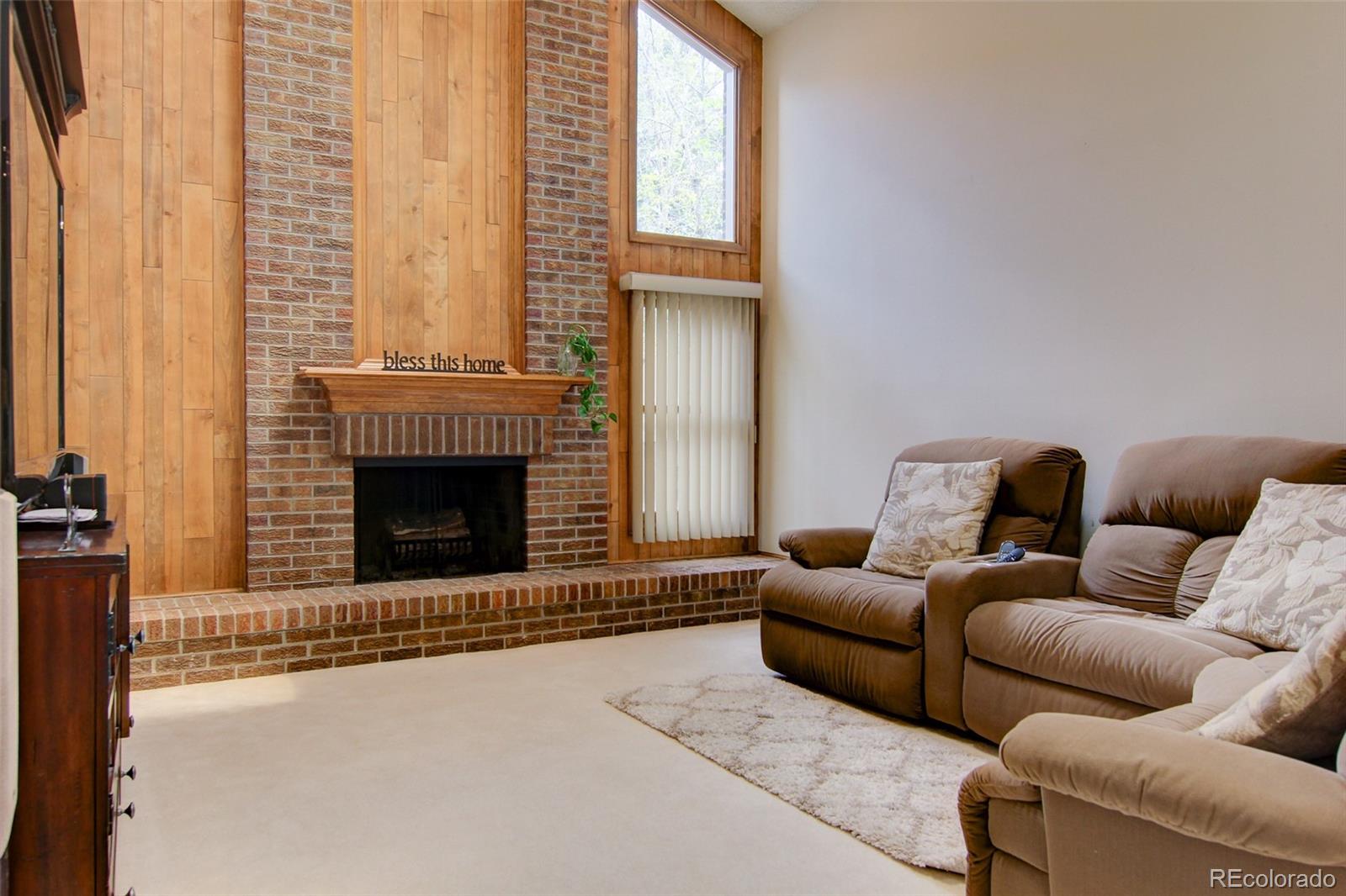 8096 Sweet Water Road Lone Tree, CO 80124 - Photo 9 of 25 a living room with furniture and a fireplace