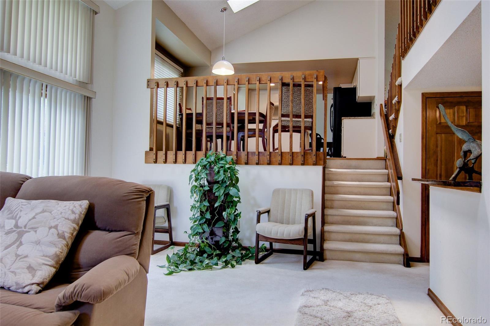 8096 Sweet Water Road Lone Tree, CO 80124 - Photo 10 of 25 a living room with furniture and stairs