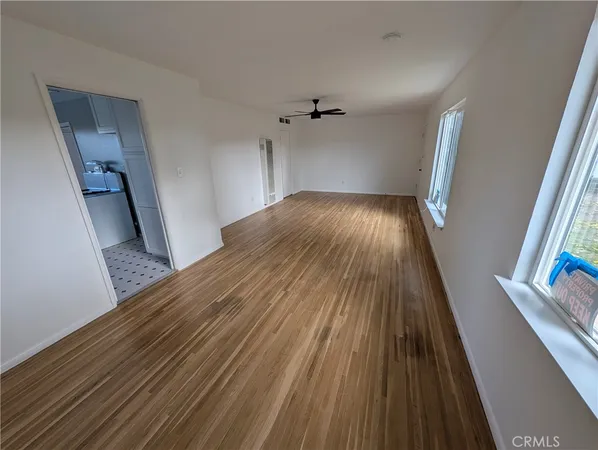 wooden floor in a hall with an empty room