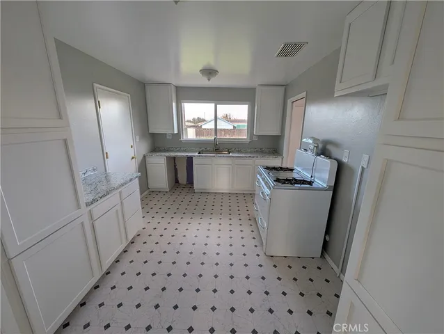 a kitchen with a stove a sink and a refrigerator