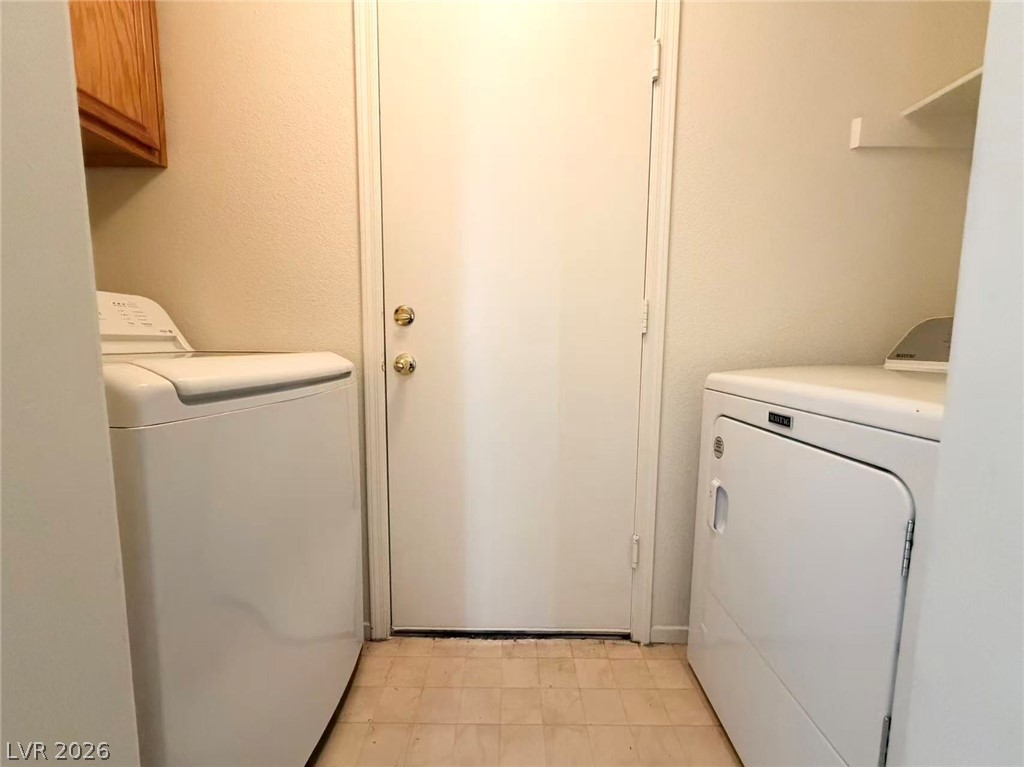8620 Magnolia Ridge Avenue Las Vegas, NV 89134 - Photo 12 of 15 Functional laundry space with a clean aesthetic and convenient shelving.