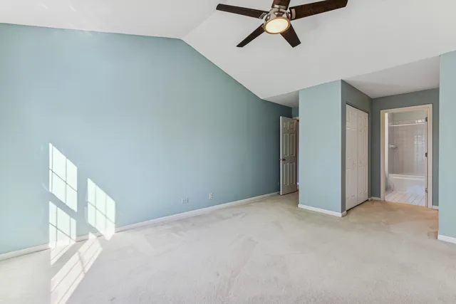 a view of a livingroom with a ceiling fan and window