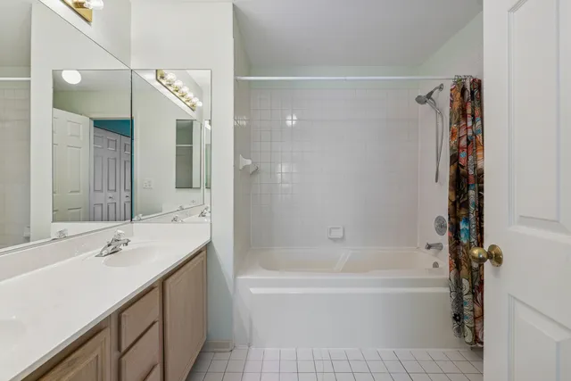 a bathroom with a bathtub a mirror a sink and vanity