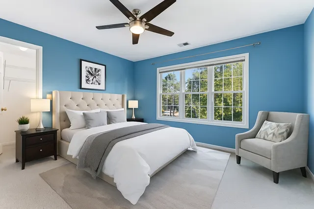 a spacious bedroom with a bed and a couch