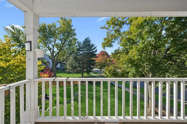 a side view of a house with a flower garden